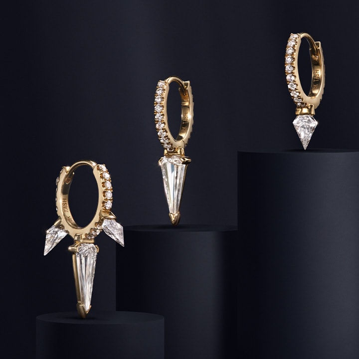 White diamond earrings featuring yellow gold hoops with diamond spikes