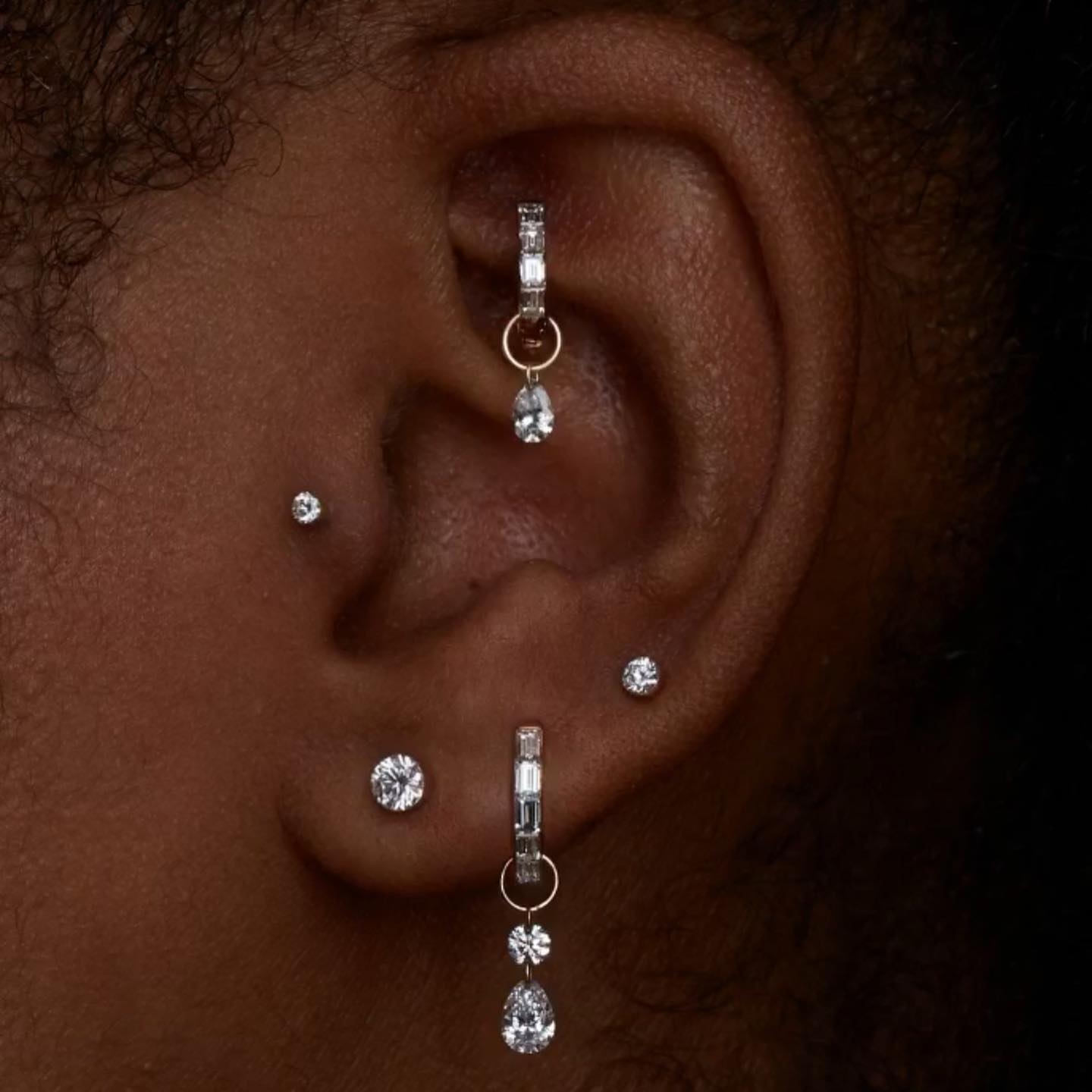 Invisible set diamond earrings in lobe, cartilage, rook, and tragus piercing placements